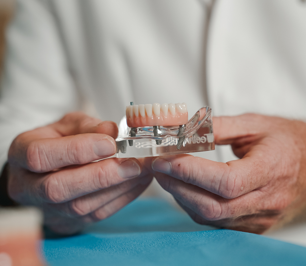 Surgeon walking a patient through her implant treatment plan